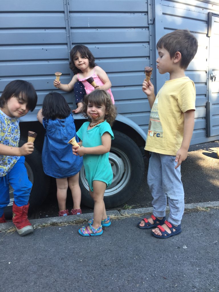 children eating ice cream in front of food truck